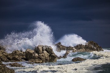 Dramatic big stormy crashing waves splash. Kleinmond, Western Cape, South Africa.