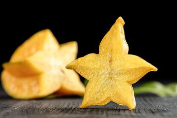 slice ripe star fruit carambola or star apple ( starfruit ) on dark background