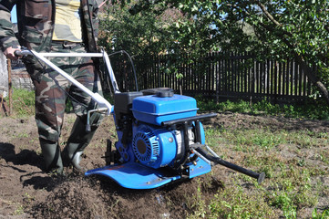 autumn field work. land cultivation with a motor cultivator