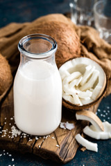 Fresh coconut milk in glass bottle, vegan non dairy healthy drink