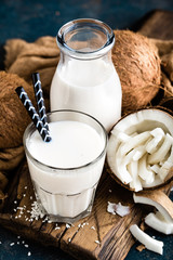 Fresh coconut milk in glass and bottle, vegan non dairy healthy drink