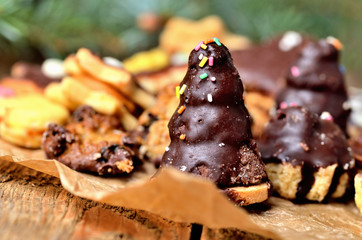 Christmas sweets background with different types of candy on baking paper and Christmas decorations