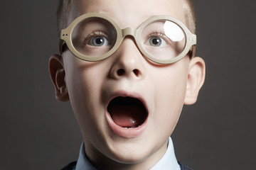 screaming child in glasses