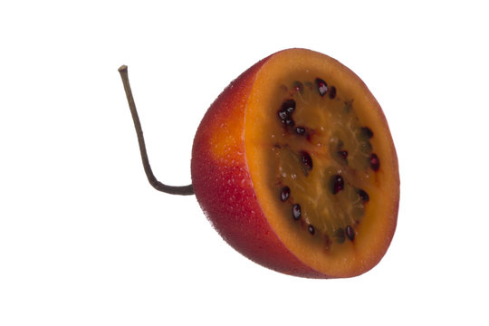 half of tamarillo isolated on white background