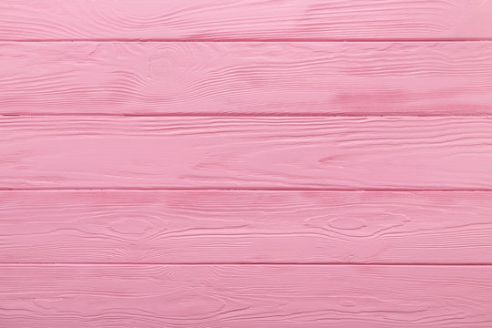 Pink texture of a wood table. Coloured background. 