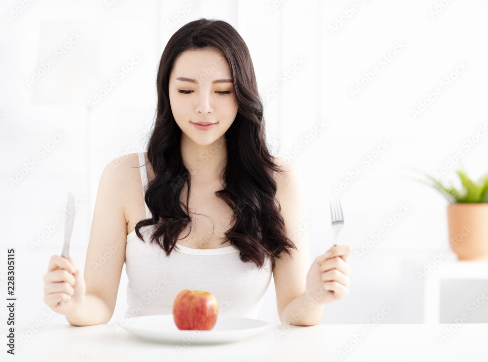 Wall mural young woman eating apple fruit