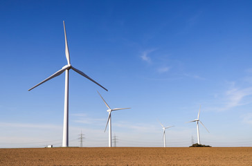 Fototapeta premium Wind turbines generating electricity with blue sky