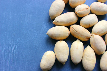 Fototapeta na wymiar Pecan nuts on a wooden table close-up. Healthy food, healthy lifestyle, diet, vegetarianism.