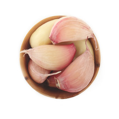 heap of garlic in wooden cup isolated on white background