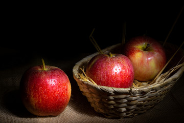Fresh red apples on rustic background