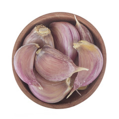 heap of garlic in wooden cup isolated on white background