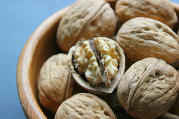 Walnuts close-up on wooden table. Healthy food, healthy lifestyle, diet, vegetarianism.