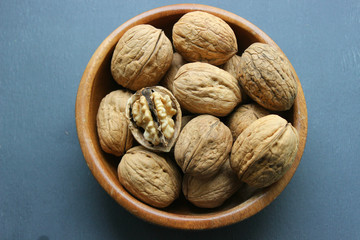 Walnuts close-up on wooden table. Healthy food, healthy lifestyle, diet, vegetarianism.