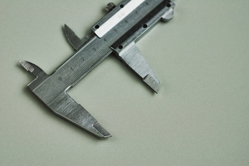 Vernier caliper of gray color on gray table with copy space for your text