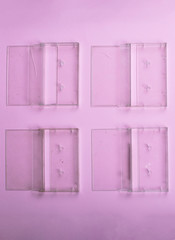 Set of old cassettes covers  on a light pink surface