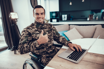 Military Man in Wheelchair Uses Laptop Thumbs Up