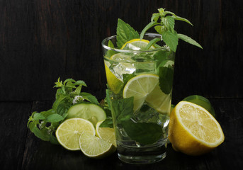 mojito with lemon, mint and ice isolated on wooden background