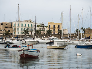 Fototapeta na wymiar Sea bay and fishing boats on the background of beautiful, Italian, old houses