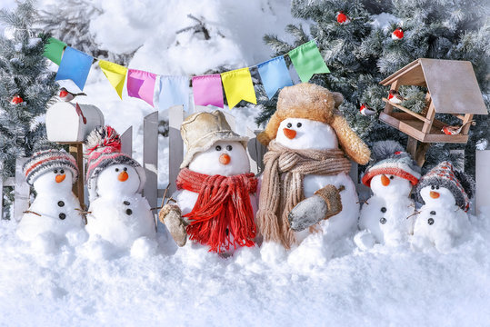 Postcard with Christmas and a new year with  cute snowmen