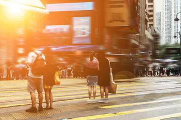 walking people on the busy city street with sunlight effect