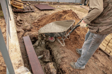 Fototapeta premium Concrete in a wheelbarrow at a construction site