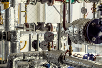 Equipment, cables and piping as found inside of a industrial workshop