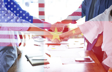 Double exposure of the flag of china and United States of America with businessmen shaking hands. Business partnership meeting and greeting concept, success, dealing, greeting and partner concept.