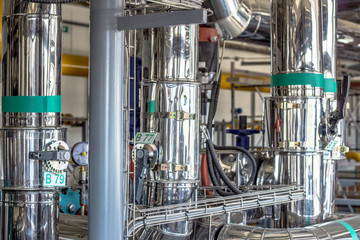 Equipment, cables and piping as found inside of a industrial workshop