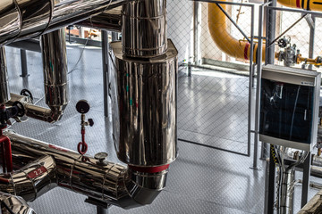 Equipment, cables and piping as found inside of a industrial workshop