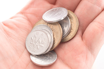 closeup photo of hand carry variety of Japanese Coin