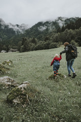Fototapeta na wymiar Austria, Vorarlberg, Mellau, mother and toddler on a trip in the mountains