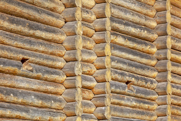 Wall with log house in the house as a background