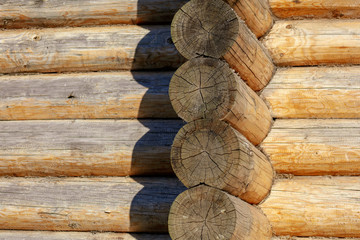 Wall with log house in the house as a background