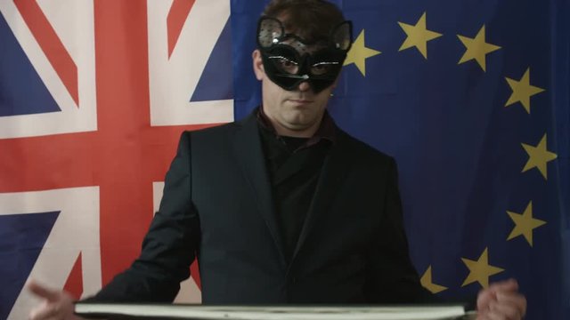 Masked Trade Negotiator Appears to Point at Documentation and Shows Negative Gesture