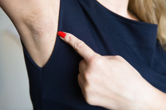 Female Finger Shows Unshaven Armpit.