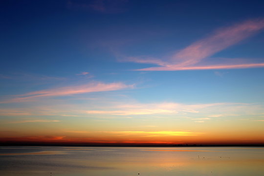 colorful sunset over the sea dark horizon