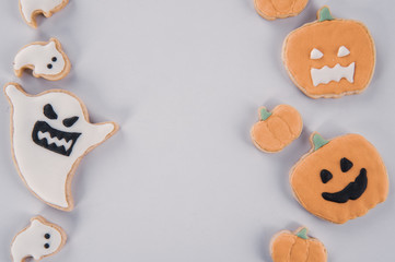 Fresh delicious homemade decorated halloween cookies sweets on dark wooden background, concept of halloween party, copy space(text space), top view, blank for text.