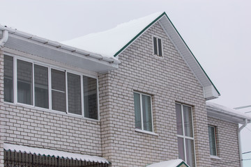 Country house cottage in the snow in winter