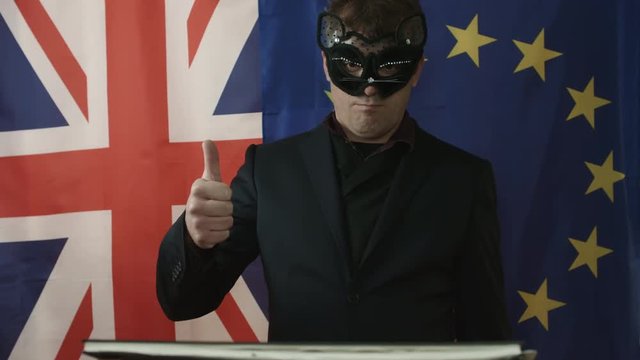 Masked Trade Negotiator Reads Documentation and Shows Positive Gesture