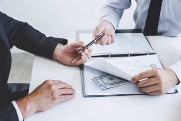 Bribery and corruption concept, bribe in the form of dollar bills, Businessman giving money while...