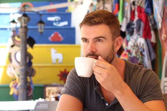 Handsome man drinking a cup of coffee 