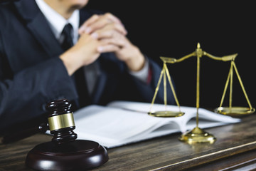 Counselor or Male lawyer working on courtroom sitting at the table. Legal law, Judge gavel with Justice lawyers advice with gavel and Scales of justice