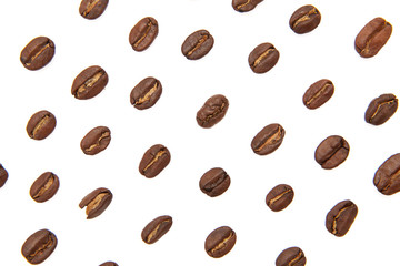 Coffee beans arranged on a white background as texture with copy space