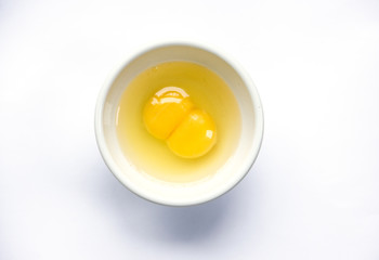 Raw egg with two yolks. Two yolks in one bowl. Raw Egg Yolks