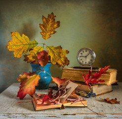 Still life with books and autumn leaves. vintage autumn colors. melancholy.