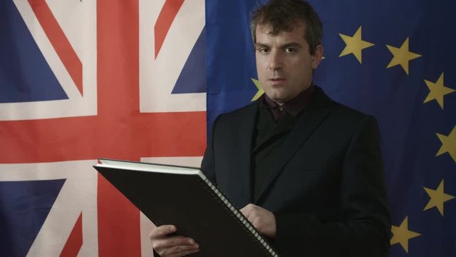 Middle Aged Trade Negotiator Reads Documentation and Shows Negative Gesture