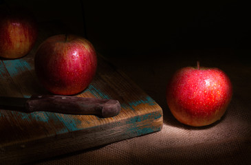 Fresh red apples on rustic background