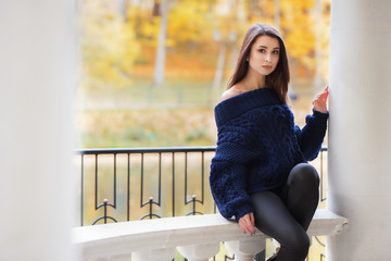 Pensive beautiful girl in autumn park