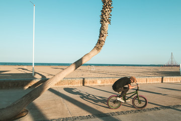 Guy riding and jumping with a bmx bike