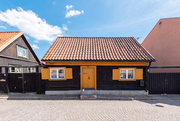 old house with roof on background of blue sky